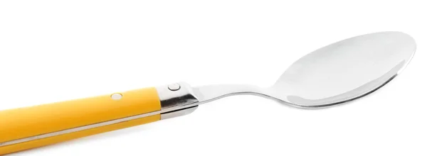 Metal spoon with yellow handle — Stock Photo, Image