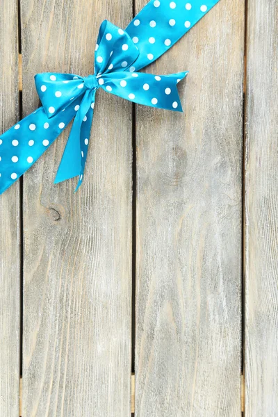 Wooden background with beautiful bow — Stock Photo, Image