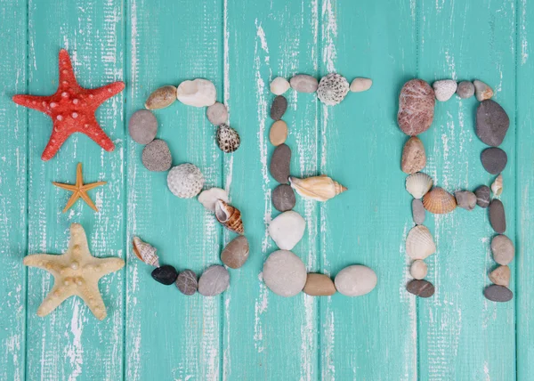 Word made from sea shells and stones — Stock Photo, Image