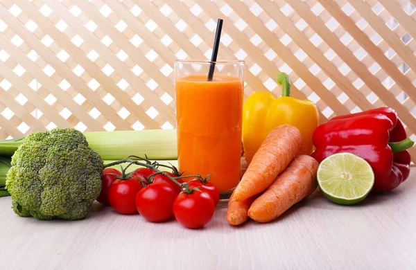 Vaso de jugo de zanahoria fresca y verduras en mesa de madera —  Fotos de Stock