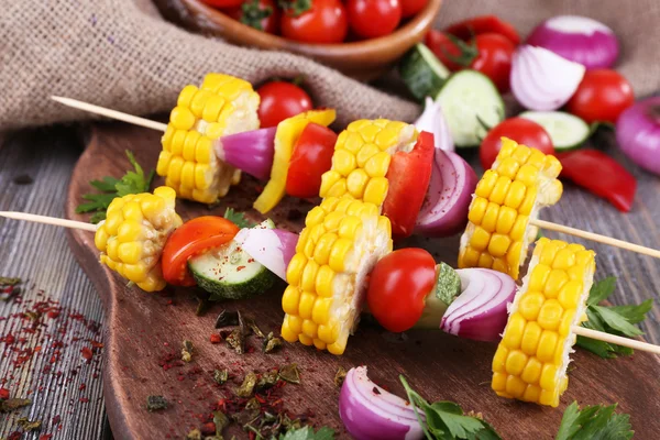 Sliced vegetables on picks on board on table close-up — Stock Photo, Image