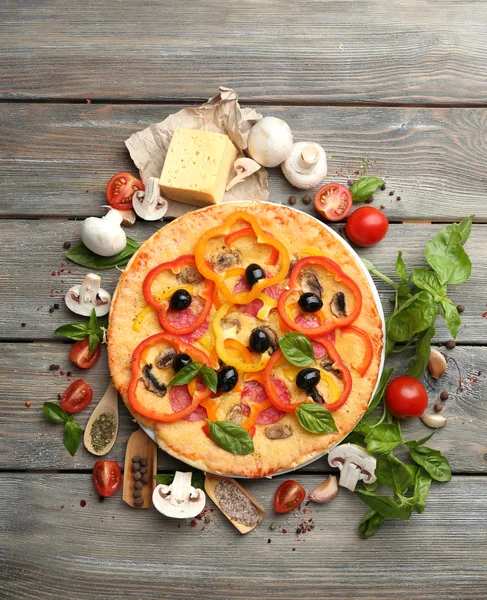 Delicious pizza served on wooden table — Stock Photo, Image