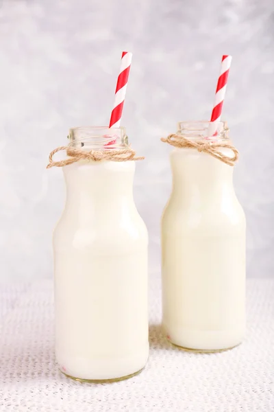 Botellas de leche sobre mesa de madera — Foto de Stock