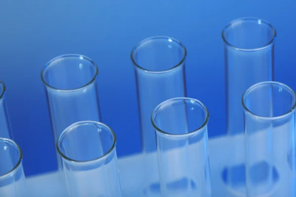 Empty test-tubes on blue — Stock Photo, Image