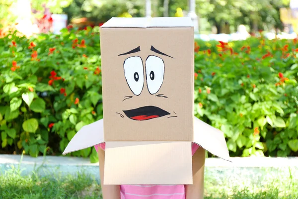 Woman with cardboard box on her head — Stock Photo, Image
