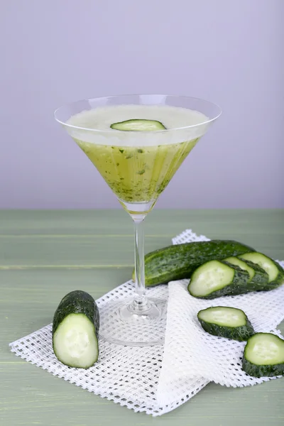 Cucumber cocktail on napkin on wooden table on light background — Stock Photo, Image