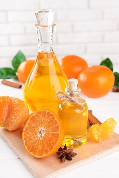 Tangerine oil on table on light background — Stock Photo, Image