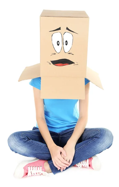 Woman with cardboard box on her head with sad face, isolated on white — Stock Photo, Image