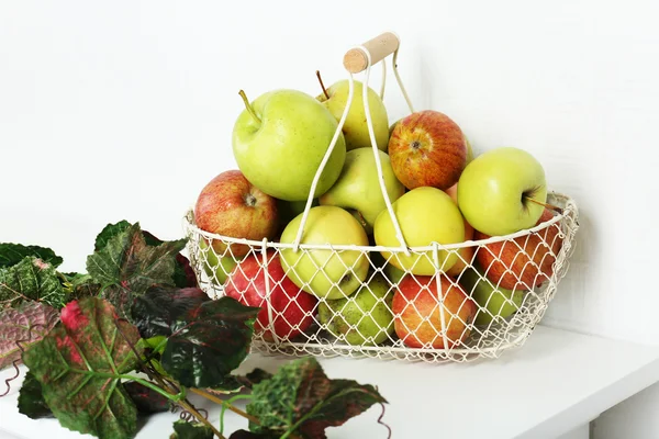 Basket of apples on white table — Stock Photo, Image