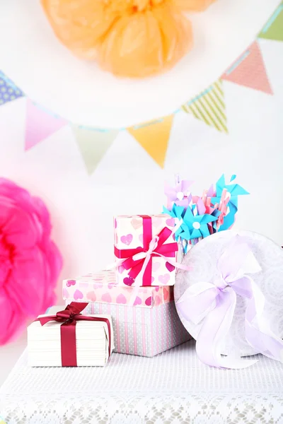 Wedding or birthday gifts on decorated table, on bright background — Stock Photo, Image