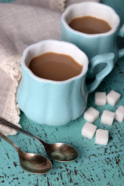 Cups of coffee with sugar and napkin on wood table — Stok Foto