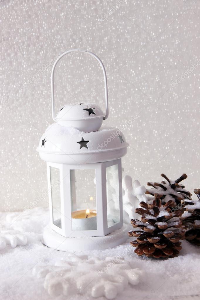 White flash light and Christmas decoration on light background