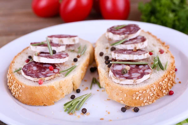 Sandwiches with salami on plate — Stock Photo, Image