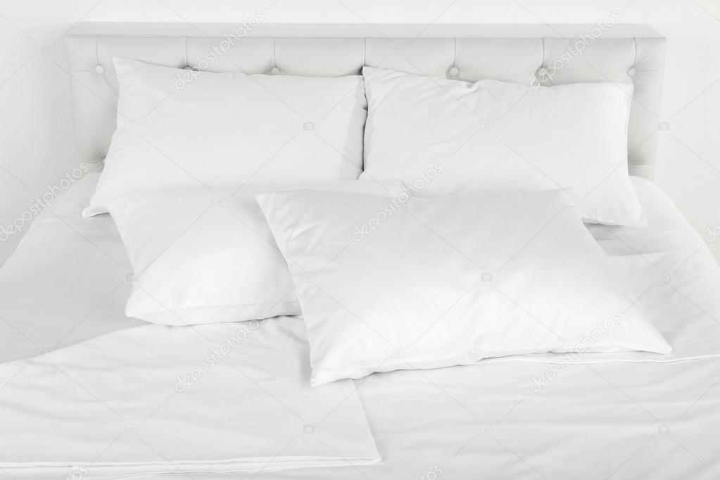 White pillows on bed close up