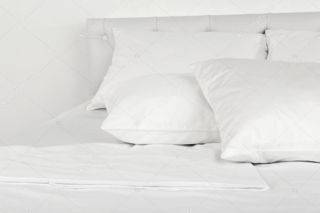 White pillows on bed in room — Stock Photo © belchonock 54251673