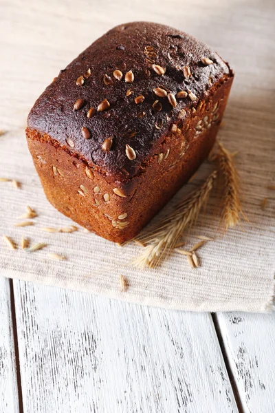 Fresh bread on wooden table, close up — Stock Photo, Image