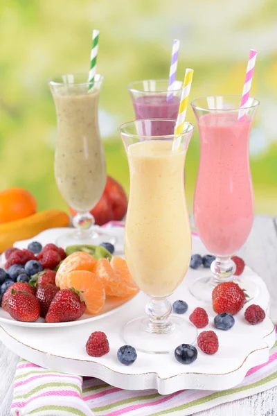 Delicious berry cocktails on table on bright background — Stock Photo, Image