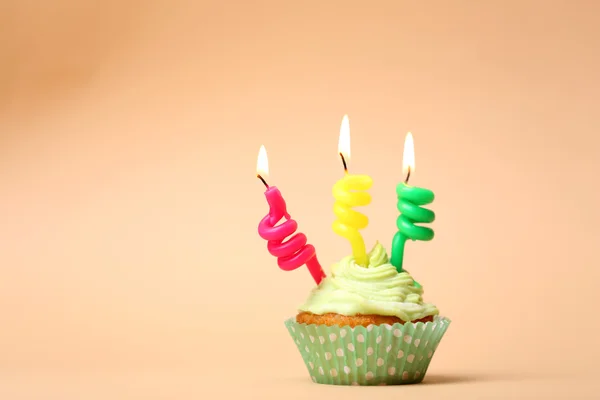 Delicious birthday cupcake on table on beige background — Stock Photo, Image