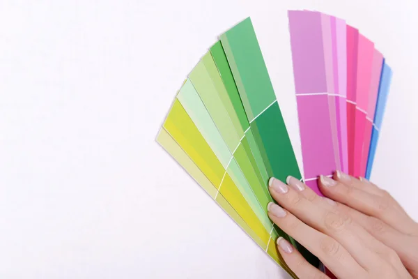 Woman choosing color for wall from swatches in room — Stock Photo, Image