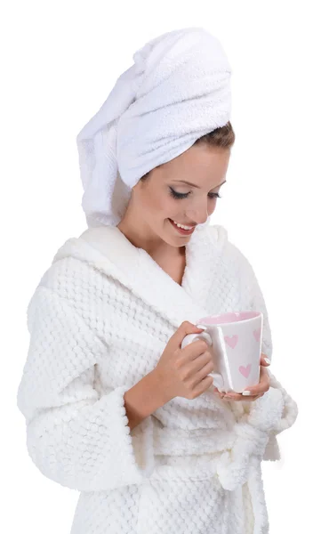 Beautiful young girl in bathrobe with cup of coffee isolated on white — Stock Photo, Image