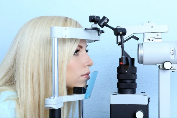 Optometria koncepcja - całkiem młoda kobieta o jej oczy, zbadane przez lekarza okulistę — Zdjęcie stockowe