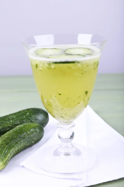 Cucumber cocktail on napkin on wooden table on light background — Stock Photo, Image