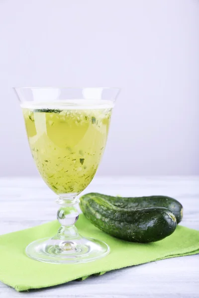 Cucumber cocktail on napkin on wooden table on light background — Stock Photo, Image