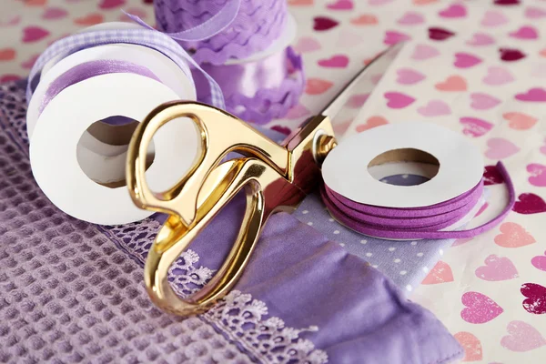 Ribbons with scissors and fabrics — Stock Photo, Image