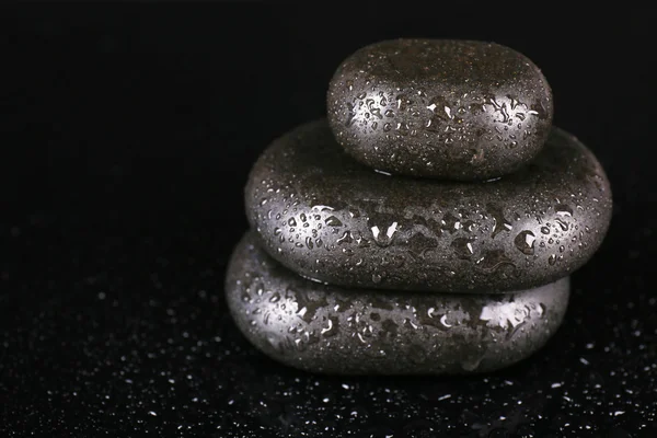 Spa stones with drops isolated on black — Stock Photo, Image