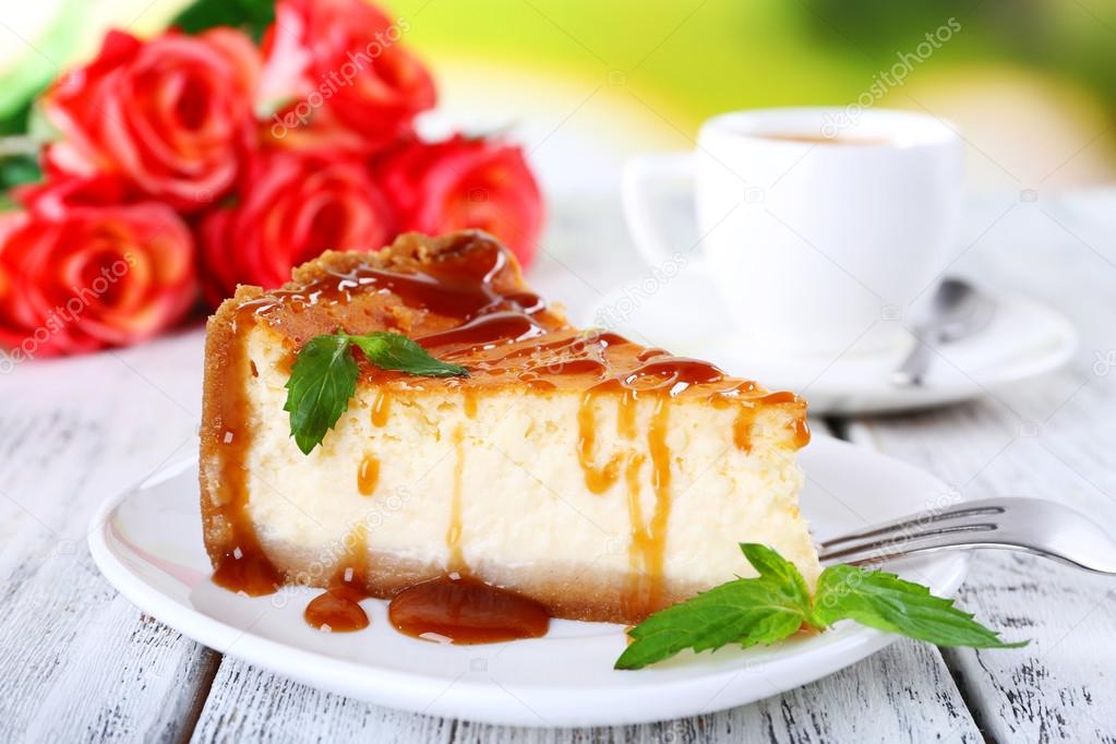 Cheese cake  in plate and tuft of roses on table on nature background