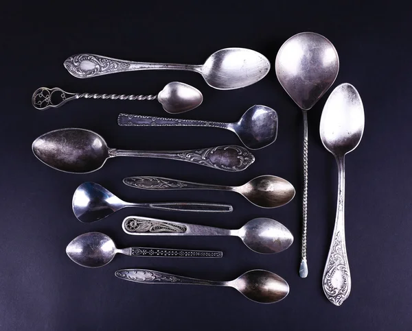 Metal spoons on black — Stock Photo, Image