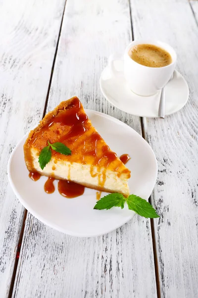 Bolo de queijo e xícara de café em fundo de madeira — Fotografia de Stock