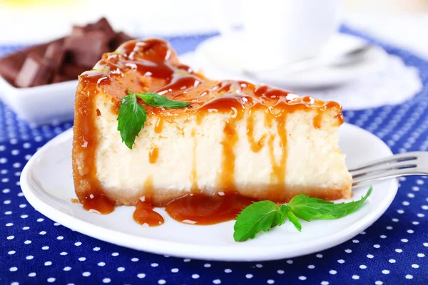 Cheese cake and cup of coffee on polka dot tablecloth — Stock Photo, Image