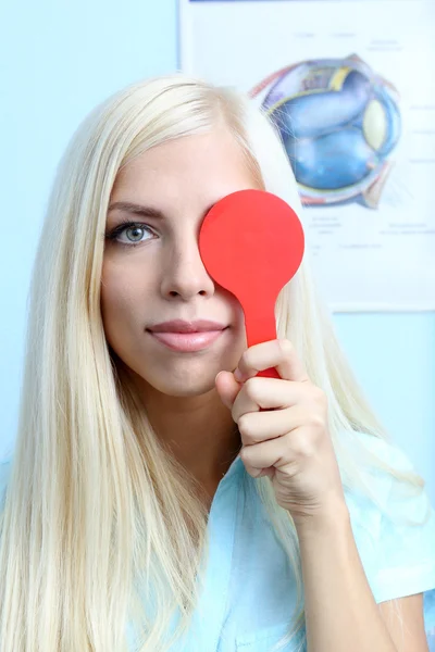 Optometry concept - pretty young woman having her eyes examined by eye doctor — Stock Photo, Image