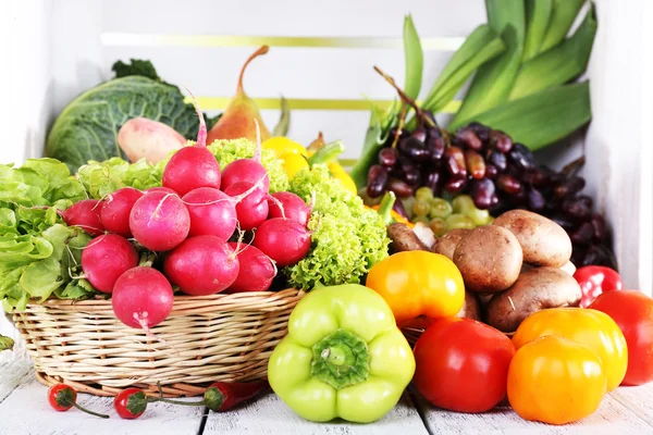 Grönsaker i korg på vit trälåda bakgrund — Stockfoto