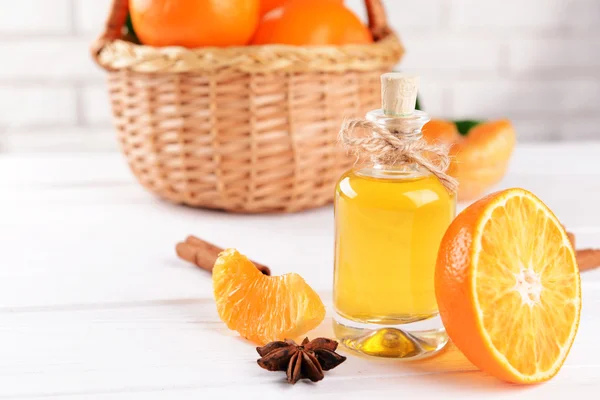 Tangerine oil on table on light background — Stock Photo, Image