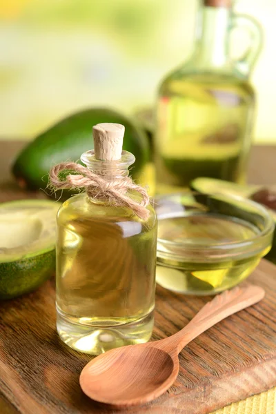 Avocado oil on table on light background — Stock Photo, Image