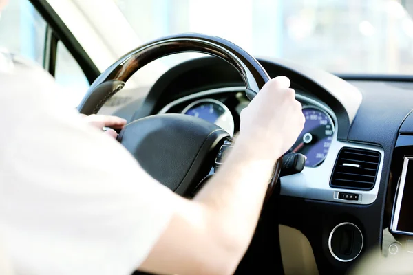 Man's hands on a steering wheel — Stock Photo, Image