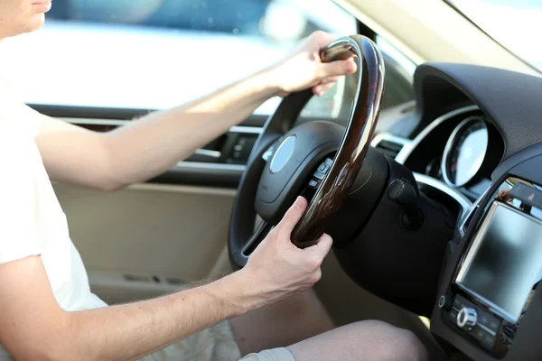 Man's hands on a steering wheel — Stock Photo, Image