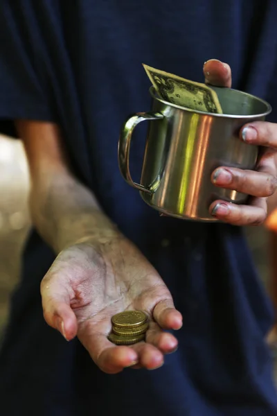 Homeless beggar money on his dirty hands — Stock Photo, Image