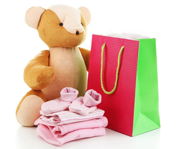 Babykleidung und Geschenktüte isoliert auf weiß — Stockfoto