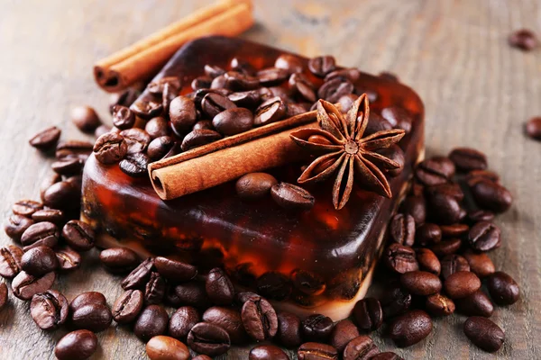 Organic soap with coffee beans and spices on wooden background — Stock Photo, Image