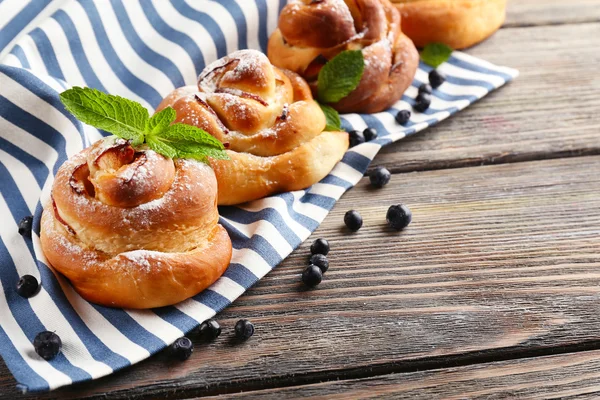 Tasty buns with berries on table close-up — Stock Photo, Image