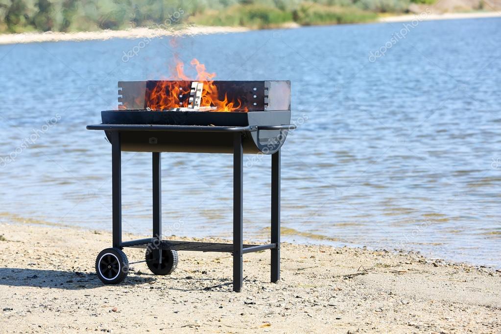 Barbecue grill on beach — Stock Photo © belchonock #54513567