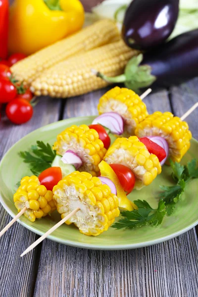 Sliced vegetables on wooden picks on plate on table close-up — Stock Photo, Image