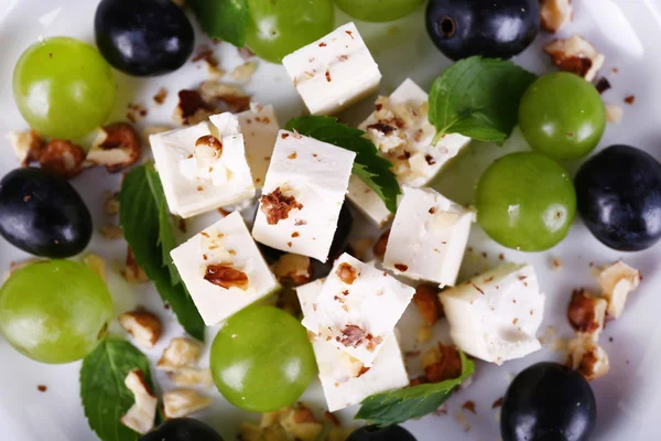 Tasty salad with grape and cheese, close up — Stock Photo, Image