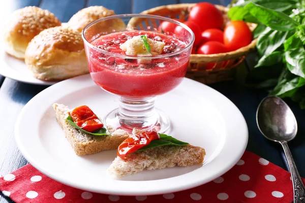 Gazpacho soup in glass bowl, on color wooden background — Stockfoto