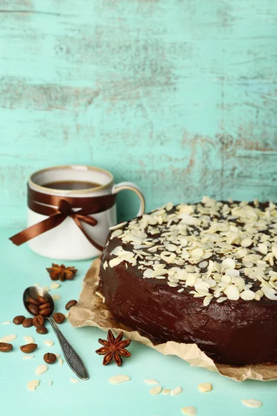 Tasty chocolate cake with almond, on old wooden table — Stock Photo, Image