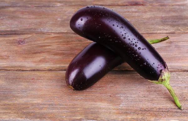 Aubergines on wooden background — Stock Photo, Image