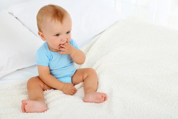 Cute baby boy on bed in room — Stock Photo, Image